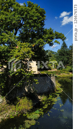 Cervena lhota castle reflecting on the calm waters in czechia Cervena lhota castle reflecting on the calm waters in czechia 126676573