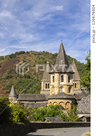 Sainte Foy Abbey Church rising above Conques village in Aveyron, France Sainte Foy Abbey Church rising above Conques village in Aveyron, France 126676804