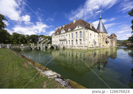 Chateau de Commarin reflecting in the moat under a blue sky in Burgundy, France 126676828