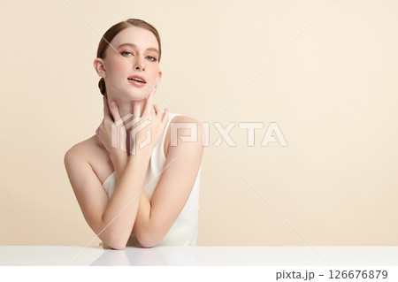A beautiful young woman with clean, fresh skin against a beige background. Skincare, facial treatment, cosmetology, beauty, and spa. An elegant portrait of an woman. A beautiful young woman with clean, fresh skin against a beige background. Skincare, facial treatment, cosmetology, beauty, and spa. An elegant portrait of an woman. 126676879