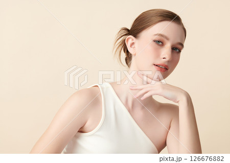 A beautiful young woman with clean, fresh skin against a beige background. Skincare, facial treatment, cosmetology, beauty, and spa. An elegant portrait of an woman. A beautiful young woman with clean, fresh skin against a beige background. Skincare, facial treatment, cosmetology, beauty, and spa. An elegant portrait of an woman. 126676882