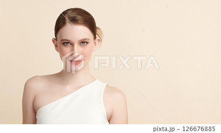 A beautiful young woman with clean, fresh skin against a beige background. Skincare, facial treatment, cosmetology, beauty, and spa. An elegant portrait of an woman. A beautiful young woman with clean, fresh skin against a beige background. Skincare, facial treatment, cosmetology, beauty, and spa. An elegant portrait of an woman. 126676885
