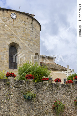 Saint Hilaire Abbey church rising over stone wall in Aude, France Saint Hilaire Abbey church rising over stone wall in Aude, France 126677034