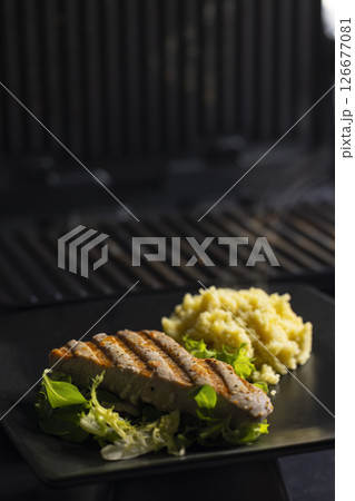 tuna fish steak with couscous and salad 126677081