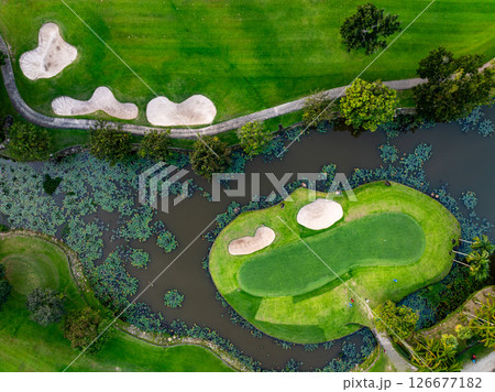 Aerial view drone shot of beautiful green golf field fairway and putting green Top down image for sport background and travel nature background Amazing view. Aerial view drone shot of beautiful green golf field fairway and putting green Top down image for sport background and travel nature background Amazing view. 126677182