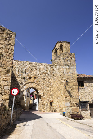 Medieval gate and bell tower dominating Calle La Virgen in Canete, Spain 126677350