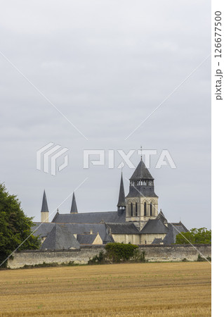 Royal Abbey of Fontevraud rising over a mowed field in the Loire Valley, France 126677500