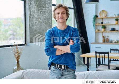 Portrait of confident happy teenage boy with crossed arms 126678363