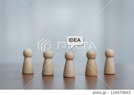 Five Wooden Figurines with Central Figure Highlighted by 'IDEA' Speech Bubble, Brainstorming Concept Five Wooden Figurines with Central Figure Highlighted by 'IDEA' Speech Bubble, Brainstorming Concept 126679663