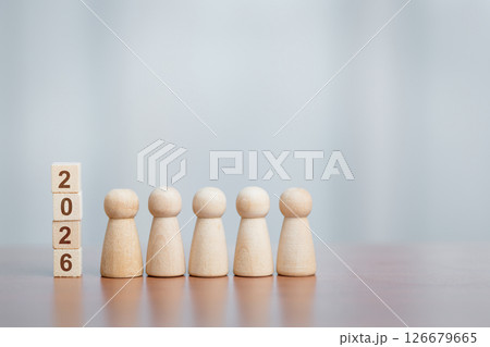 Five Wooden Figurines Standing Beside Stacked Blocks Showing '2026', Planning and Future Concept Five Wooden Figurines Standing Beside Stacked Blocks Showing '2026', Planning and Future Concept 126679665