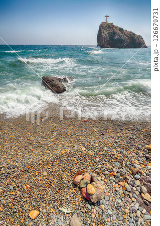 Amazing view of sea waves crashing on the shore and flowing above seashore pebbles 126679731