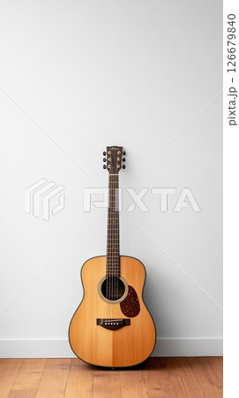 Classic acoustic guitar resting against a clean white wall in a minimalist style room, creating a serene and musical atmosphere, perfect for music lovers and aspiring musicians Classic acoustic guitar resting against a clean white wall in a minimalist style room, creating a serene and musical atmosphere, perfect for music lovers and aspiring musicians 126679840