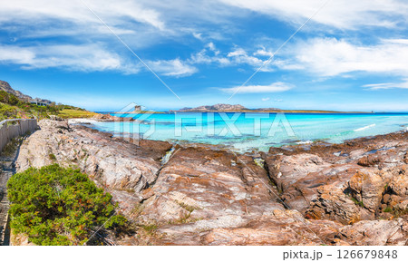 Unbelivable morning view of famous La Pelosa beach and rocky shore near Torre della Pelosa 126679848
