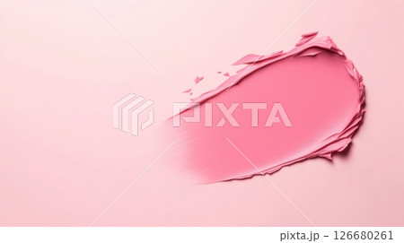 Pink cosmetic product smear is creating a soft, textured gradient on a matching pink background, offering a visually appealing backdrop for beauty and makeup concepts 126680261