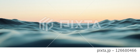 Gentle ocean waves creating mesmerizing ripples beneath a serene sunset sky, offering a tranquil and captivating glimpse into the beauty of nature's evening display 126680466
