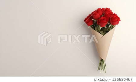 Bouquet of vibrant red roses, carefully arranged and wrapped in simple brown paper, creates a striking contrast against a clean white backdrop, evoking feelings of love, romance, and celebration 126680467