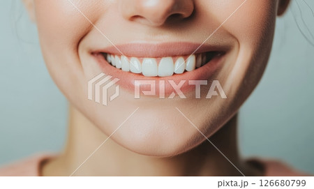 Close up capturing a perfect smile with sparkling white teeth, highlighting the importance of oral hygiene and dental care, framed by beautifully shaped lips 126680799