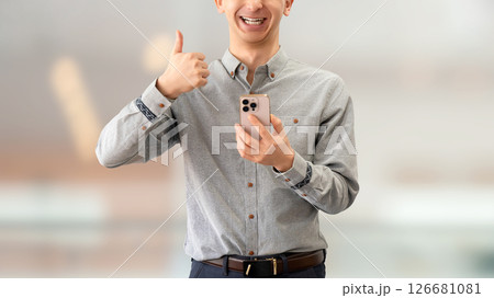 スマートフォンを持っていいね！のポーズをする男性 126681081