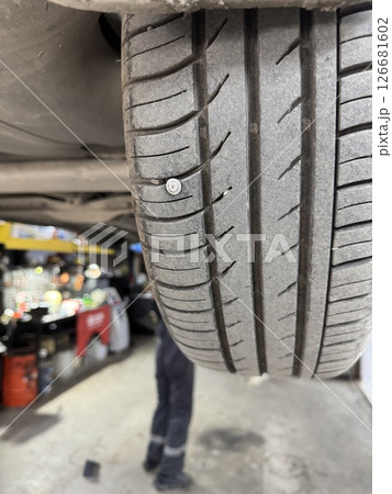 Close-up of a screw in a car wheel.  126681602