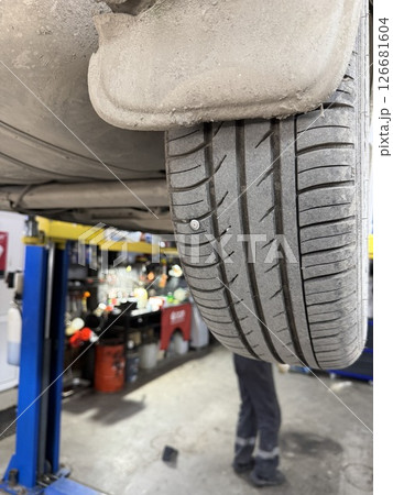 Close-up of a screw in a car wheel. Close-up of a screw in a car wheel. 126681604