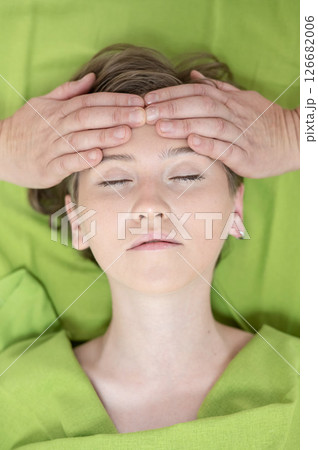 Top view of woman getting facial massage.  126682006