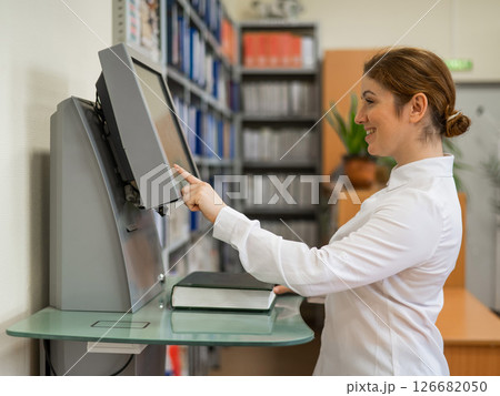 A woman in the library. Special electronic catalog. A woman in the library. Special electronic catalog. 126682050