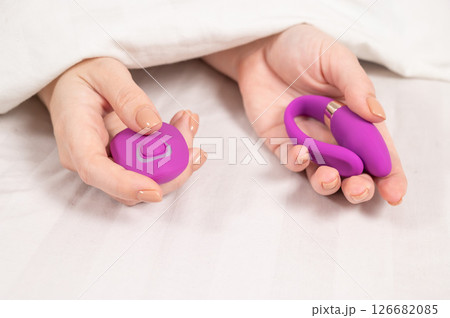 Female hand with curved remote control vibrator. Female hand with curved remote control vibrator. 126682085