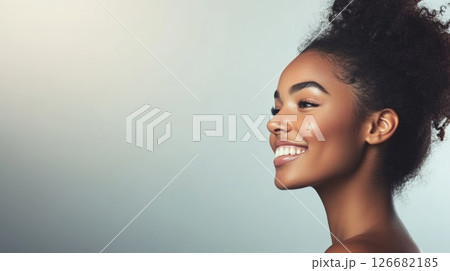 Studio beauty portrait of a gorgeous young black woman with perfect skin and white teeth smiling and showing perfect skin for beauty and cosmetics Studio beauty portrait of a gorgeous young black woman with perfect skin and white teeth smiling and showing perfect skin for beauty and cosmetics 126682185