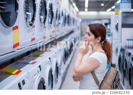 Caucasian woman chooses a washing machine in a home appliances store 126682330