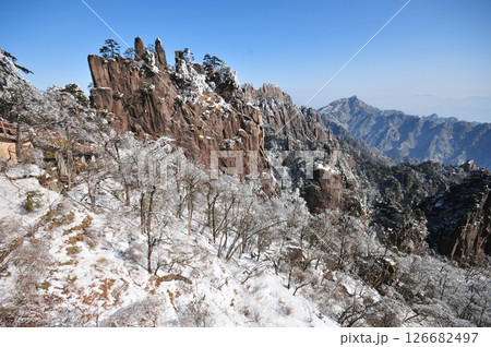 Mountain landscape after heavy snowfall, trees covered with snow and rime, China, Anhui Province, Mount Huang Mountain landscape after heavy snowfall, trees covered with snow and rime, China, Anhui Province, Mount Huang 126682497
