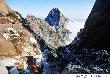 Mountain landscape after heavy snowfall, trees covered with snow and rime, sea of fluffy misty clouds ,China, Anhui Province, Mount Huang Mountain landscape after heavy snowfall, trees covered with snow and rime, sea of fluffy misty clouds ,China, Anhui Province, Mount Huang 126682524