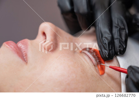 Caucasian woman undergoing eyelash lamination procedure.  126682770