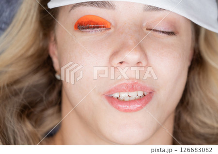 Caucasian woman undergoing eyelash lamination procedure.  126683082