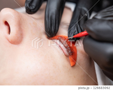 Caucasian woman undergoing eyelash lamination procedure. Caucasian woman undergoing eyelash lamination procedure. 126683092