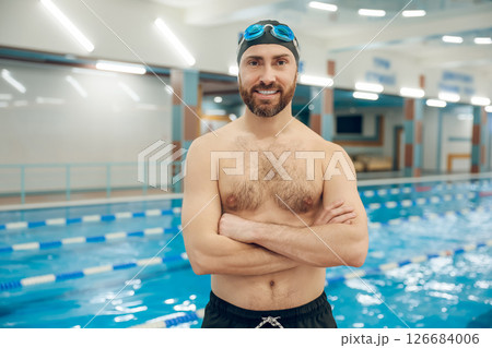Confident bearded young caucasian man in the swimming pool Confident bearded young caucasian man in the swimming pool 126684006
