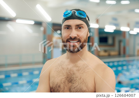 Confident bearded young caucasian man in the swimming pool Confident bearded young caucasian man in the swimming pool 126684007