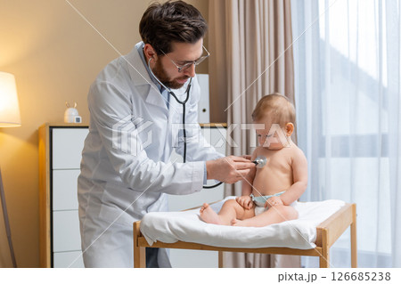 Doctor holding a stethoscope and listening to the babys heartbeat Doctor holding a stethoscope and listening to the babys heartbeat 126685238