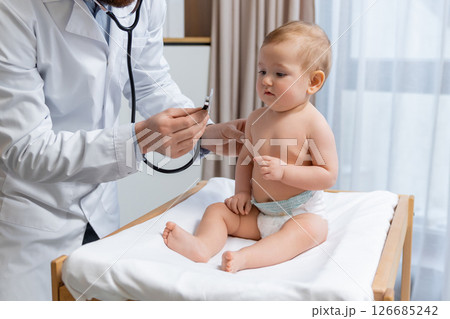 Cute little baby boy having an exam at the doctors office Cute little baby boy having an exam at the doctors office 126685242