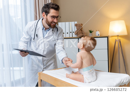 Pediatrician examining a cute little baby boy in his office 126685272