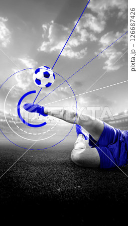 Footballer finishes powerful sliding kick under dramatic sky as digital lines and dots highlight impact and direction. Conceptual art collage. Monochrome. Poster 126687426