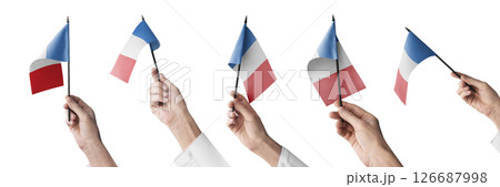 The France flag in hand in different angles on a white background The France flag in hand in different angles on a white background 126687998