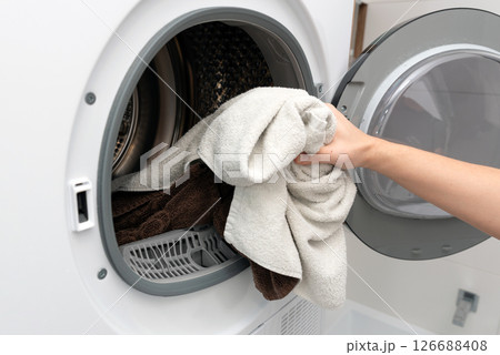 Using washing machine at home, household chores Using washing machine at home, household chores 126688408