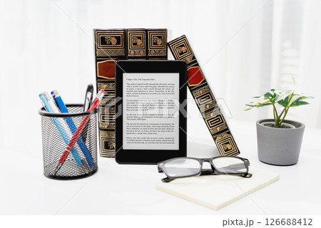 E-book reader device in home library 126688412