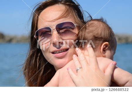 Happy Moment: Mother Holding Baby by the Water 126688522