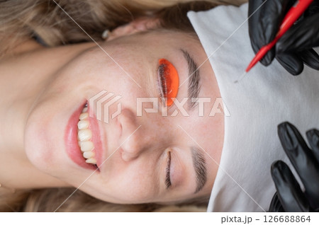 Caucasian woman undergoing eyelash lamination procedure.  126688864