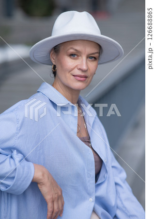 Portrait of stylish mature woman in white hat.  126688865