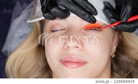 Caucasian woman undergoing eyelash lamination procedure.  126688928