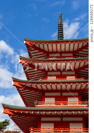 Chureito Pagoda vibrant red tiers contrast against a deep blue sky 126689273