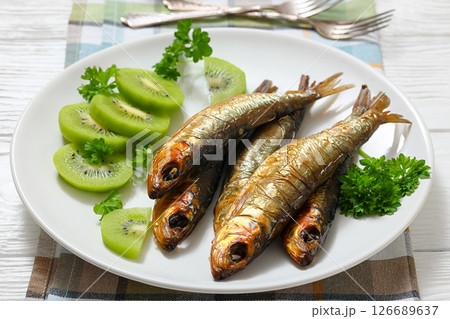 Hot smoked Baltic herrings with kiwi fruit slices 126689637