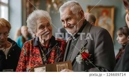 An elderly Chernobyl survivor couple receive a prestigious pension award, beaming with pride and joy. An elderly Chernobyl survivor couple receive a prestigious pension award, beaming with pride and joy. 126689714